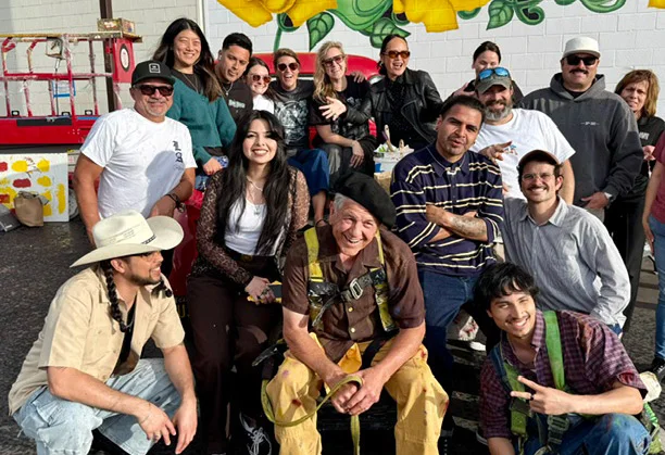Behind-the-scenes crew gathered near the mural.