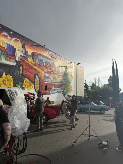 Crew members working along the mural wall.