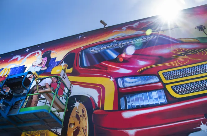 Sunlit view of the mural in progress.